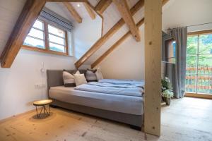 a bedroom with a bed in a room with wooden beams at Ferienwohnung Rohrmoser in Bad Oberdorf