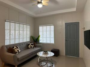 a living room with a couch and a table at Japandi Home C - Fully Aircon, WIFI, Hot shower, 24hGuard, Center, near Malls in General Santos