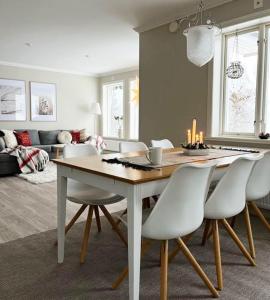 a dining room with a table and white chairs at Charming cottage in Forsa, Hudiksvall with lake view in Hudiksvall