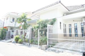 a white fence in front of a house at OYO 93710 Bidara Guest House Syariah in Mojokerto