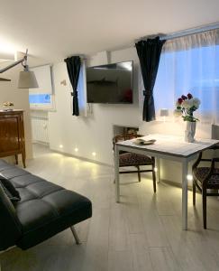 ein Wohnzimmer mit einem Tisch und einem Sofa in der Unterkunft Casina Tuareg in Livorno