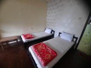 En eller flere senger på et rom på Capital O 93733 Hotel Linggarjati Kuningan
