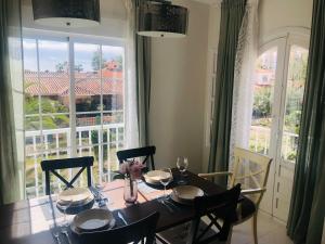 a dining room with a table and a large window at Apartamento Andaluz CARMA in Torrox Costa