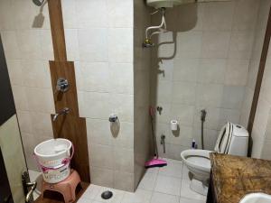 a small bathroom with a toilet and a shower at Moon Walk in Dharamshala