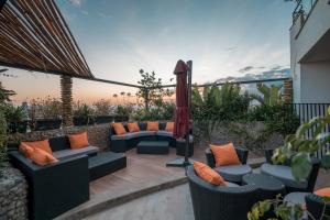 an outdoor patio with couches and an umbrella at Monarch Hotel in Addis Ababa