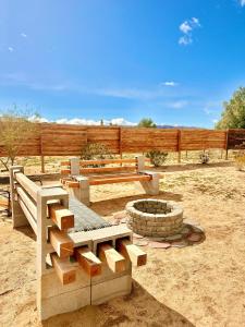 a park with a bench and a fire pit at Casa Del Desierto - Panoramic Views - Pet Friendly - Fire Pit in Joshua Tree