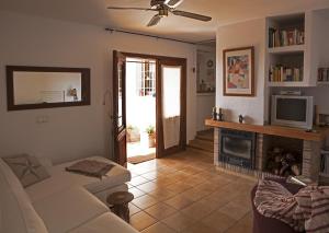 a living room with a couch and a fireplace at Hacienda Ses Caletes in Cala San Vicente