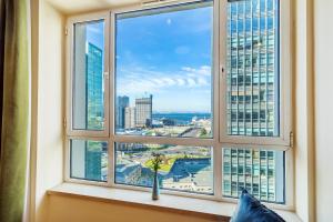a window with a view of a city at Dalian Baobab Apartment in Dalian