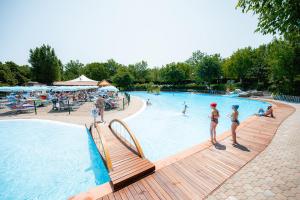 a group of people in a swimming pool at Glamping San Marino in San Marino