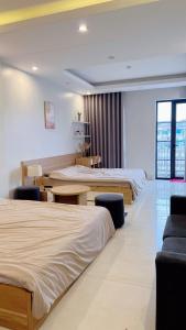 a hotel room with two beds and a table at Ez mart and stay in Hai Phong