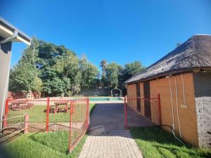 a gate to a building with a pool at De Prince Lodge in Vereeniging