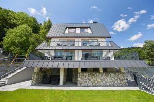 a house with a metal roof at EveRest Apartamenty Szczyrk in Szczyrk