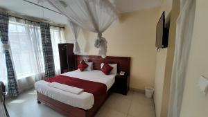 Postel nebo postele na pokoji v ubytování Epitome Times Hotel