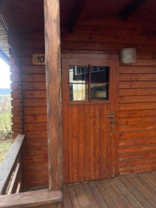 a wooden door on the outside of a cabin at Autokemp s koupalištěm in Nový Jičín
