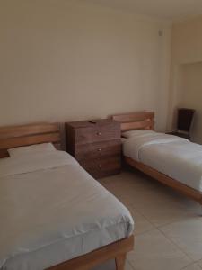 a room with two beds and a desk and a chair at Lunis in Geghanist