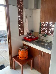a kitchen with an orange pot sitting on a table at Quaint one bedroom guest house near main airport in Nairobi