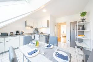 a kitchen and dining room with a table and chairs at Nice Apartment in Blankenfelde-Mahlow in Blankenfelde