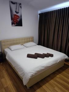 a bed with two brown pillows on top of it at Mirage in Chernivtsi