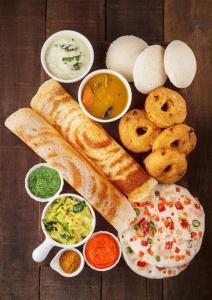 a plate of food with bread and different types of dips at Dash Hotels - Affordable Luxury in Hyderabad