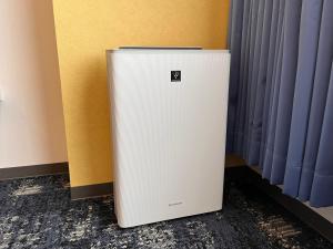 a white refrigerator sitting next to a wall at Hotel Keihan Universal Tower in Osaka