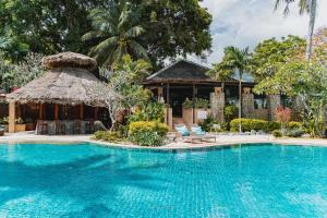 a swimming pool in front of a villa at Racha Kiri Resort & Spa, Khanom in Khanom