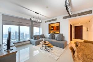 a living room with a couch and a table at Spectacular Burj Khalifa & Fountain View 2 Bedroom Apartment, 29 Boulevard Tower in Dubai