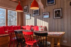 a dining room with red chairs and a table at City Lights Zakopane in Kościelisko