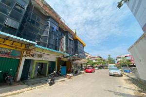 a street with cars parked on the side of a building at SPOT ON 93776 Intan Homestay in Nagoya