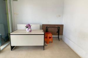 a room with a white desk with a potted plant at SPOT ON 93776 Intan Homestay in Nagoya