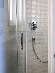 a shower in a bathroom with a glass door at Relais Villa Borghese in Rome