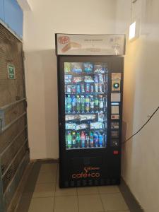 a vending machine filled with bottles of soda at Design apartments Brno-center in Brno