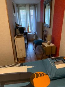a bedroom with a bed and a living room at chambre proche Gerardmer in Fraize