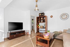 a living room with a couch and a tv at Villa Baobab - Plusholidays in Ifach