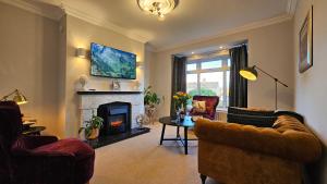 sala de estar con sofá y chimenea en Cherrymount Cottage, Enniskillen en Enniskillen