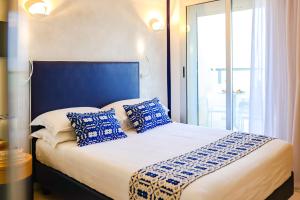 A bed or beds in a room at UNAHOTELS Imperial Sport Hotel