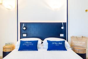 A bed or beds in a room at UNAHOTELS Imperial Sport Hotel
