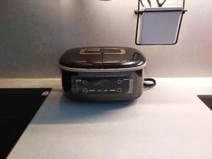 a black toaster sitting on a counter in a room at Coex Stay in Seoul