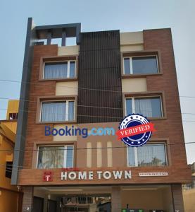 a building with a home town sign on it at Goroomgo Hotel Home Town Near Golden Beach Puri in Puri