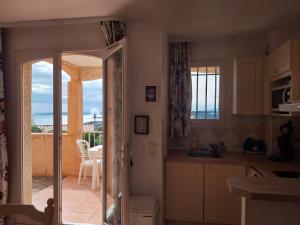 a kitchen with a view of the ocean from the balcony at résidence Bellevue in Roquebrune-sur-Argens
