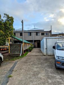 a white van parked in front of a house at GRAND CENTRAL HOTEL PROSERPINE in Proserpine