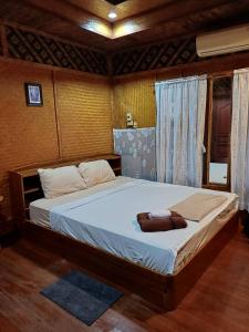 a bedroom with a bed with a purse on it at Orchid Home in Ko Tao