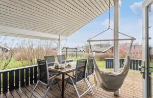 a porch with a hammock and a table and chairs at 2 Bedroom Stunning Home In Rudkbing in Spodsbjerg