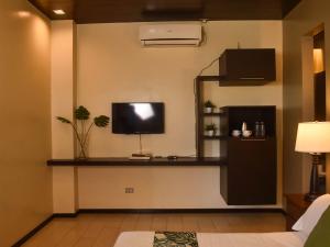 a living room with a tv on a wall at Stay Inn Plus in Mexico