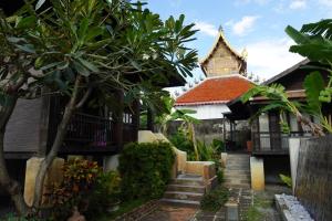 a building with a staircase leading to a building with a tower at Baan Saen Fang Chiang Mai - SHA Plus in Chiang Mai