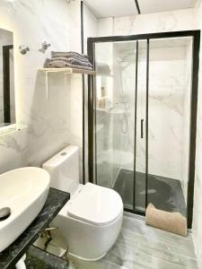 a bathroom with a toilet and a sink and a shower at JARA HOME Malaga Centro in Málaga