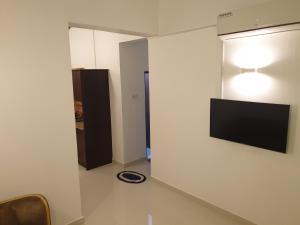 a room with a flat screen tv on a wall at Bevons Place in Piliyandala