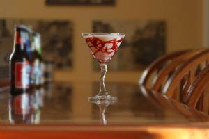 a wine glass sitting on a table with a bottle at Hale Springs Inn in Rogersville