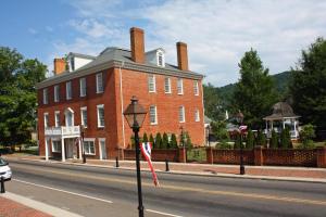 a large red brick building on the side of a street at Hale Springs Inn in Rogersville