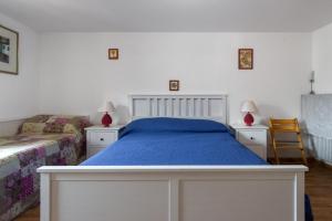 a bedroom with a bed and two tables and two chairs at DolomiApartments - Appartamento Girasole in Predazzo