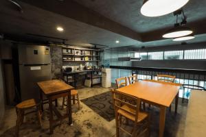 a kitchen and dining room with tables and chairs at Once in a Blue Moon Cafe and Hostel in Chiang Mai